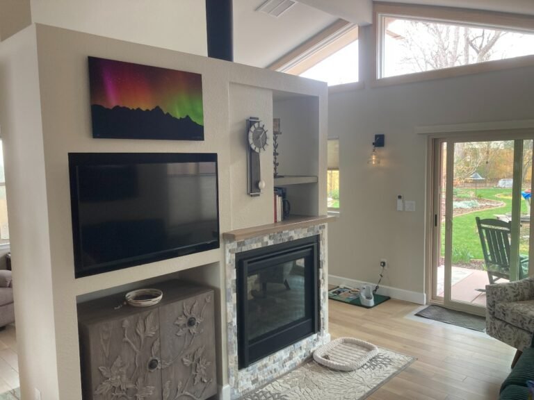Finished living area with fireplace and glass doors by Culligan Construction